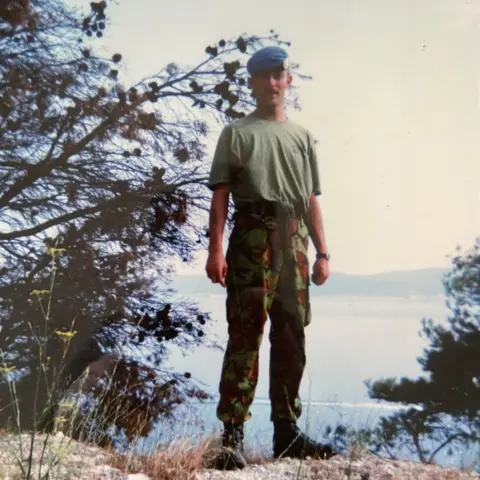 LEE Lee Thomas as a younger age stood on a hill