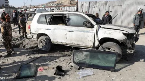 Reuters Afghan security officials inspect the site of a bomb blast in Kabul, Afghanistan December 15, 2020
