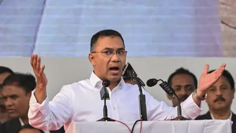 Tarique Rahman, son of former prime minister Khaleda Zia and Bangladesh Nationalist Party (BNP)'s acting chairman addresses supporters during a rally after his arrival in Dhaka on December 25, 2025. Aspiring prime minister and political heavyweight Rahman was welcomed back to Bangladesh on December 25 by huge crowds of joyous supporters after 17 years in self-imposed exile. (Photo by Munir UZ ZAMAN / AFP via Getty Images)