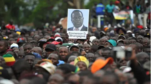 Getty Images Crods wait for Mr Mnangagwa