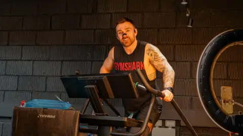 Luke Ansell Luke during his challenge, smiling for the camera.