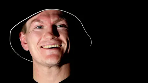 PA Media Close-up of Ricky Hatton in the dark with his trademark black bucket hat with a white rim