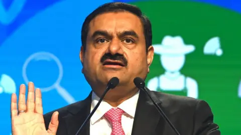 Getty Images Indian billionaire Gautam Adani faces critical report before family-run company goes public.