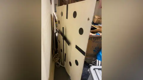 Matt Bradley An image showing the old Highfield clock with black spots and dashes used for the numbers. Cardboard boxes can be seen behind it.