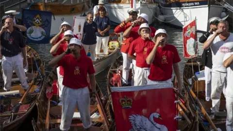 Getty Images Teams raise a toast to the Queen at the end of the first day