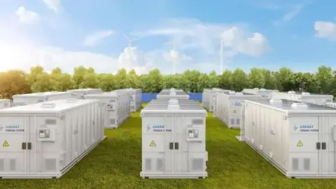 Getty Images A battery energy storage system, with units spread across a grass plot in a rural landscape.