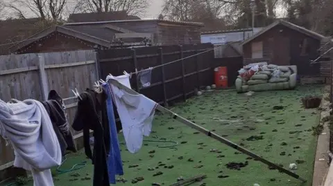 Hull City Council A lawn covered in dog foul and an old sofa