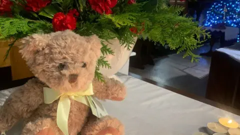 BBC Photo of teddy bear in church at Christmas
