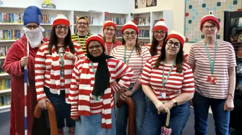 SBL Academy A group of staff members at Sir Bernard Lovell Academy in Oldland Common line up for the camera on World Book Day. They are all dressed as the character Wally from the "Where's Wally" books, wearing red stripey shirts and hats