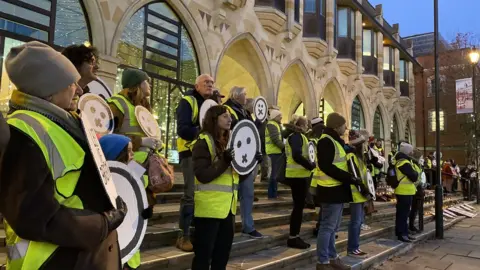 Umbrella Fair Organisation Protesters in Northampton standing in the town centre campaigning for better air quality