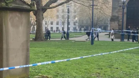 Blue police tape in place in Cathedral Square in Birmingham