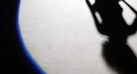 Getty Images The shadow of a model is cast on the runway at the J Maskrey collection, 2003