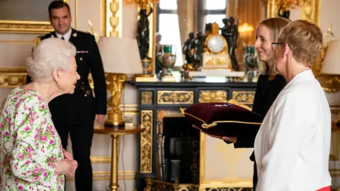 Reuters The Queen awarding the George Cross to Judith Paget CBE, chief executive of NHS Wales, and Dr. Ami Jones MBE