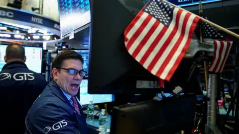 Getty Images Wall Street trader and flag