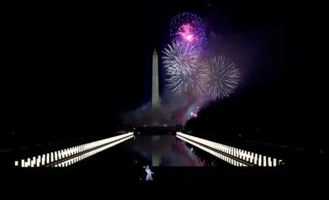 Getty Images Katy Perry (foreground) performs amid the fireworks at the Washington Monument at a televised ceremony at the Lincoln Memorial on January 20, 2021 in Washington, DC.