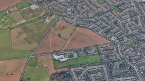 Google An Google image from above shows The Triangle, other fields to the left and streets mainly on the right of the photo.