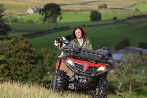 George Carrick Photography Hannah Jackson on her quad bike with her dog