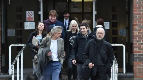 PA Media Jordi Casamitjana (front right) leaves an Employment Tribunal in Norwich after it ruled that ethical veganism is a philosophical belief and is therefore protected by law