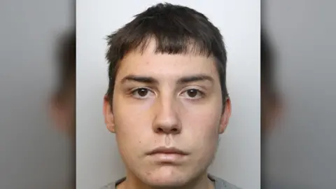 Derbyshire Police Logan Procter with a grey background
