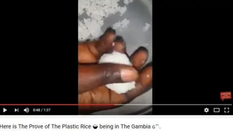 YouTube Photo of a ball of rice in a hand: A video showing which falsely claims to 'prove' the existence of fake plastic rice in the food supply
