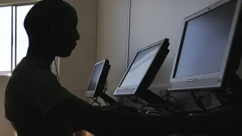 Getty Images People in a cyber cafe