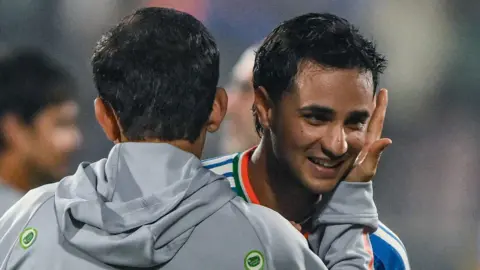 India head coach Gautam Gambhir (left) embraces batter Abhishek Sharma (right) after victory over New Zealand