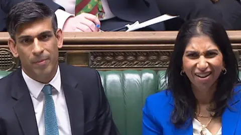 Rishi Sunak sits on the front bench with Home Secretary Suella Braverman