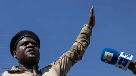 Reuters Former police officer Jimmy "Barbecue" Cherizier, leader of the 'G9' coalition, speaks during a press tour of the La Saline shanty area of Port-au-Prince, Haiti November 3, 2021.