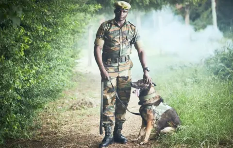 WWF Kenyan Wildlife Service (KWS) ranger Edwin Koech, with his dog Ram, during a training session for sniffer dogs and their handlers at the Kenya Wildlife Service (Marine Park) offices.