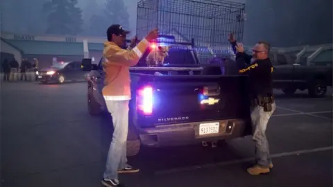 EPA A dog is loaded up into a cage on a police van in Butte County