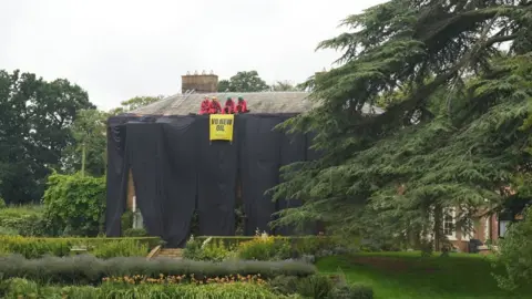 Protestors on the roof of a house