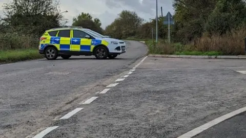 A police car blocking a road