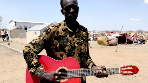 Hassan Lali/ BBC Man with a guitar