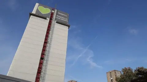 PA Media Grenfell Tower with tribute banner