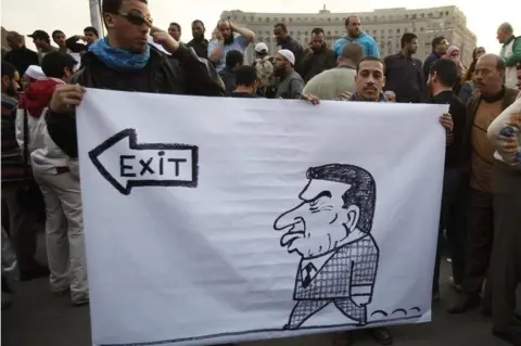 Reuters Protesters hold caricature of Egyptian President Hosni Mubarak in Cairo in 2011