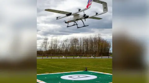 NHS Drone in the air above a landing pad