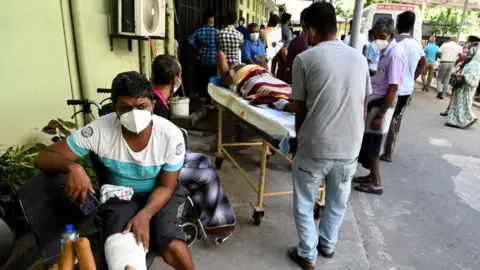 Getty Images Patients wait for treatment at a Colombo hospital amid a health worker strike over lack of resources in February