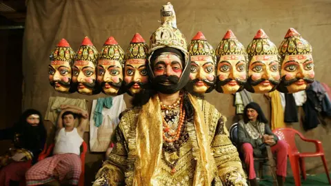 Getty Images An artist dressed up as th 10 faced Ravana from the mythological Ramayana at Shivaji Park for a Ram Lila show on the occasion of Dassera.