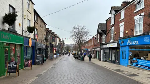 A view of a row of shops in High Street, Belper, Derbyshire
