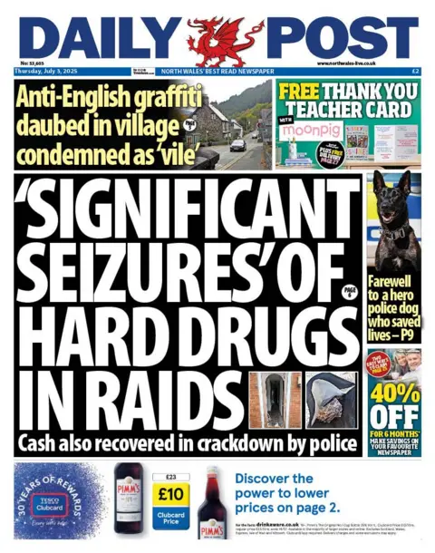 Daily Post Front page of the Daily Post. Main headline reads: 'Significant seizures' of hard drugs in raids. Other headlines read: Anti-English graffiti daubed in village condemned as 'vile'. There is an advert to the right for moonpig and a headline with a picture of a dog that reads "farewell to a hero police dog who saved lives - p9" Under that is an offer for 40% off and under there is an advert for Tesco.