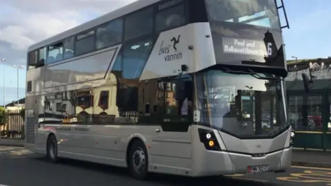 A silver double-decker bus at the Lord Street bus interchange. It has the Bus Vannin logo on the side and the number 6 along side Peel and Ballawattleworth on the display above the windscreen.