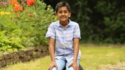 Meera Naran Boy sitting in a garden