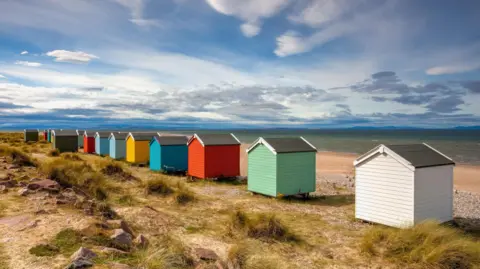 Getty Images Different coloured beach huts at Findhorn.