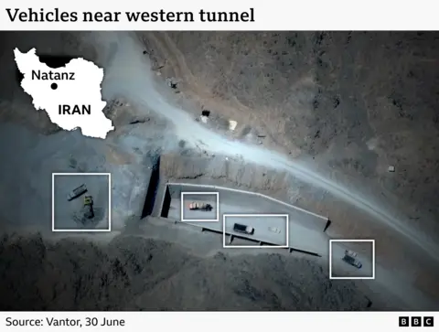 A satellite image showing several trucks near a tunnel entrance at the Pickaxe Mountain facility.