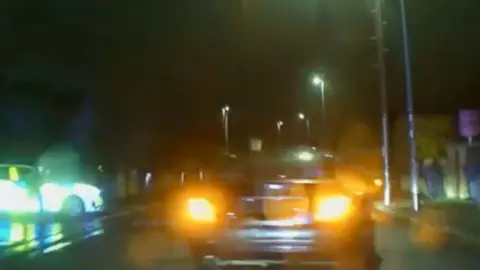 Car speeds through residential area in Peterborough at night