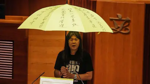 Getty Leung Kwok-hung held a yellow umbrella in LegCo