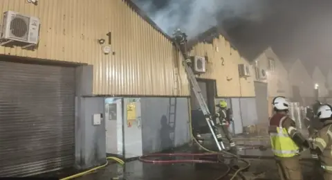 Firefighters at the scene of a suspected arson attack