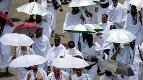 Getty Muslim pilgrims arrive at the Mina tent camp during the annual Hajj pilgrimage near the holy city of Mecca on June 14, 2024