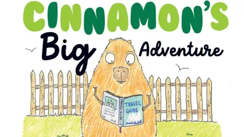 The front cover of a book - it is a cartoon-style drawing of a capybara standing in a field reading a book. The top of the cover has the author's name Tracey J Morgan and the title Cinnamon's Big Adventure.