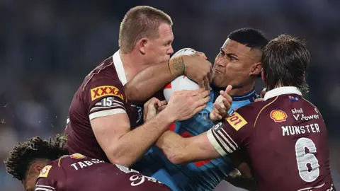 Haumole Olakau'atu of New South Wales is tackled during the game